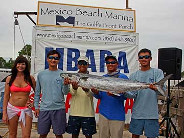 Andrew Nguyen, second from right, and Christopher Nguyen, far right, earn third place in a kingfish tournament in Florida in August 2015, with a 37.78-pound catch. Christopher says he enjoys being on the water for fun, but will not follow his father into the shrimping industry. (Courtesy: Dung Nguyen and the Mexico Beach Artificial Reef Association)