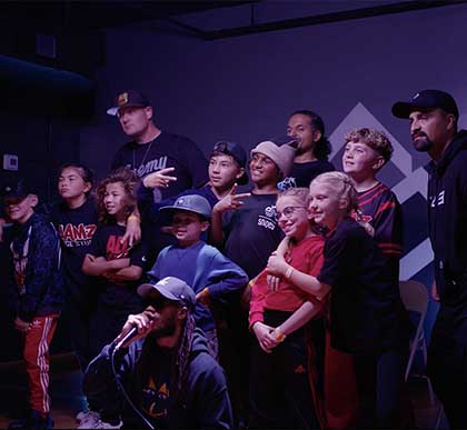 Photo of children posing with Antonio Castillo at The Lab Breakin’ Academy. 