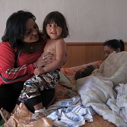 Photo of Xhensila Bukri holding her son in Tirana, Albania.