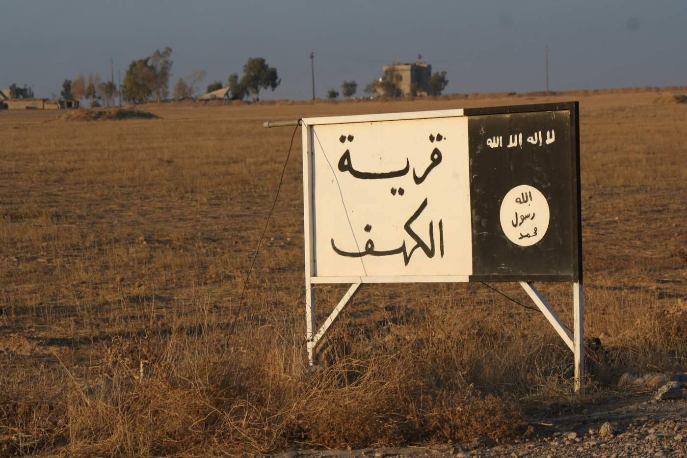 Infrastructure like this road signs saying &quot;The Village of al-Kahf&quot; along with the IS logo in the countryside south of Mosul demonstrate how deeply entrenched the militant group became into local societies. (H. Murdock\/VOA) Dec. 11, 2016)