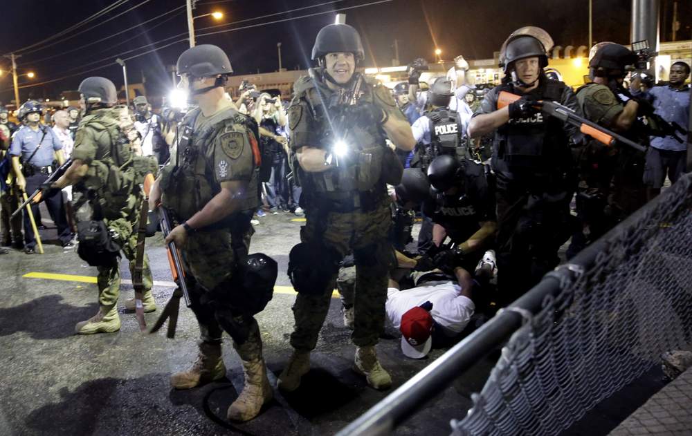 Police arrest protester to disperse crowd, August 2014:Photo AP