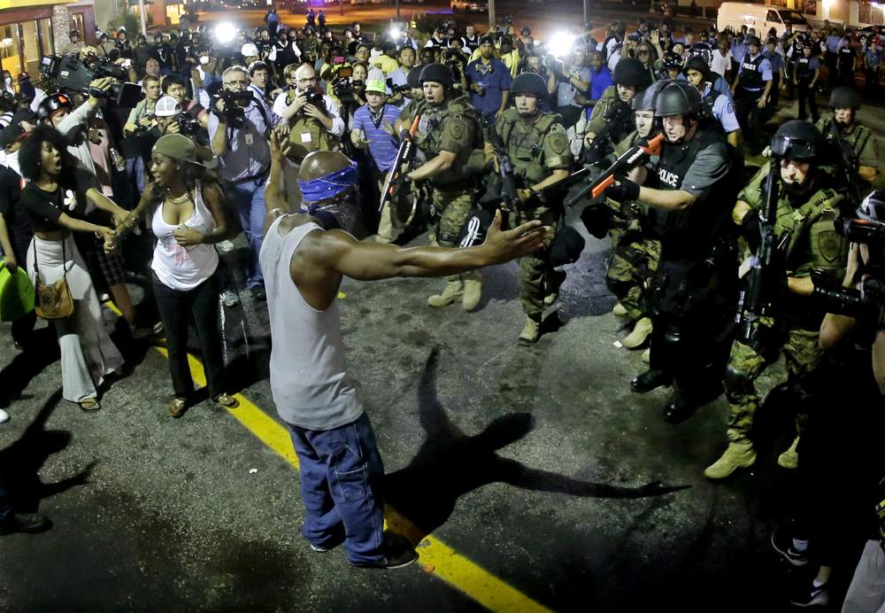 Police arrest protester to disperse crowd, August 2014: Photo AP