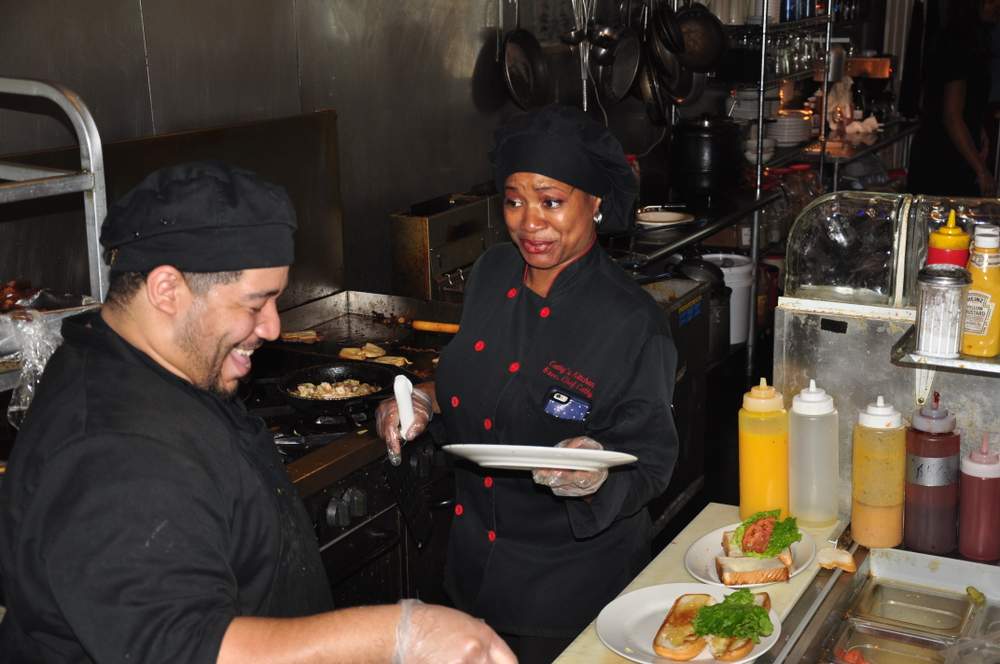 Jenkins, center, and employee working in kitchen: Photo Chris Simkins