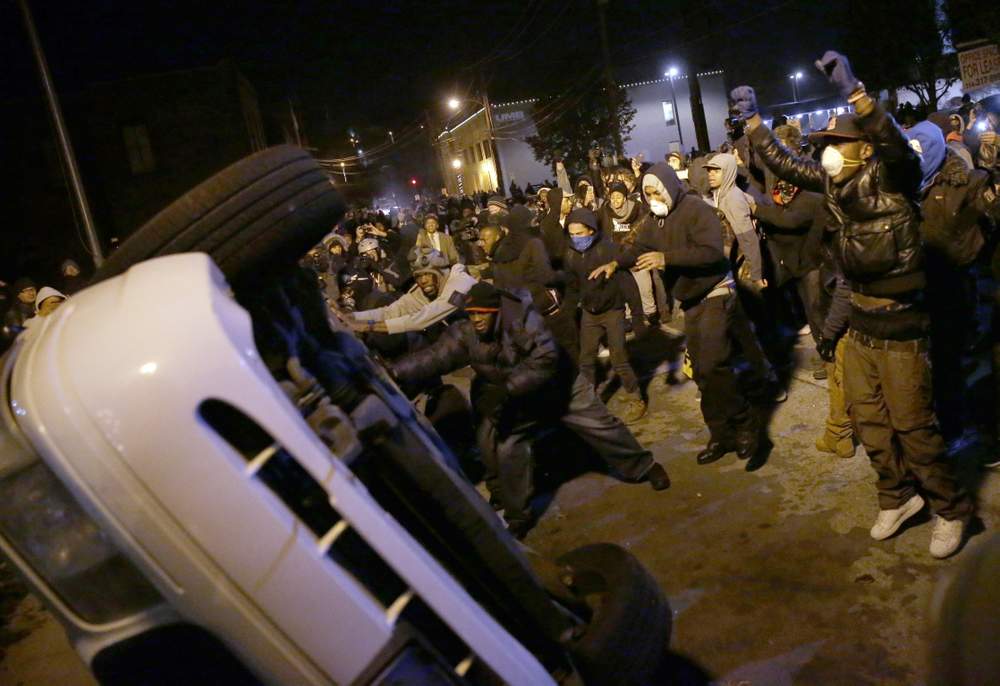 Crowd rolls police car: Photo AP