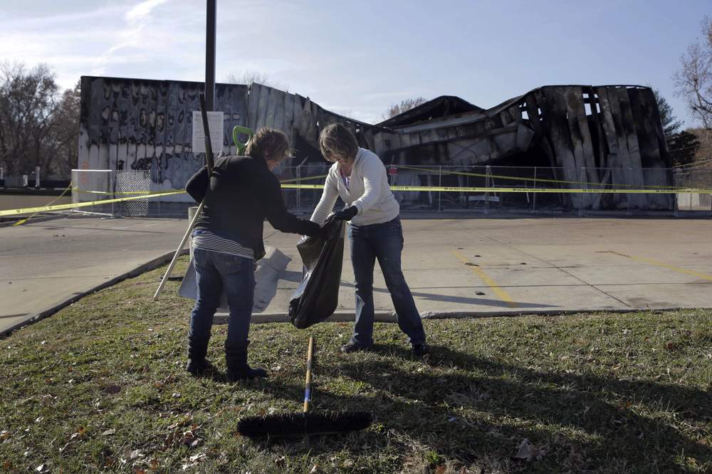 Emily Davis and friend help clean along West Florissant, November 2014: Photo AP