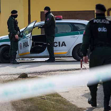 Police gather outside the Velka Maca home where Jan Kuciak and his fiancée, Martina Kusmirova, were shot dead in February 2018.  