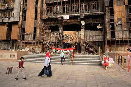 People walk by the entrance of Mosul University’s Central Library, decorated with balloons and Iraqi flags, as Mosul’s young volunteers celebrate their successful campaign to rescue thousands of books after the Islamic State took control of the building in 2014. 