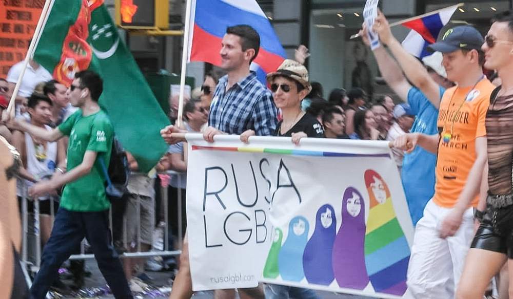 Oleg Jelezniakov, left, marches with the RUSA LGBT float at the New York City Gay Pride Parade in June 2013. Writer and activist Masha Gessen, right, carries the banner with Jelezniakov.