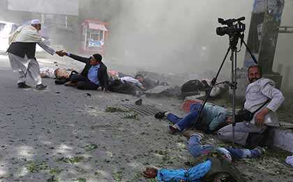 Afghan media pictured in the aftermath of a blast in Kabul in April 2018. The double bombing killed nine journalists. 