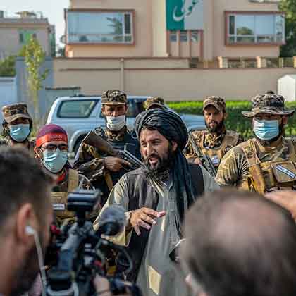 A Taliban commander speaks to members of the media after they halted a demonstration by women protestors happening in front of a school in Kabul on September 30, 2021. 