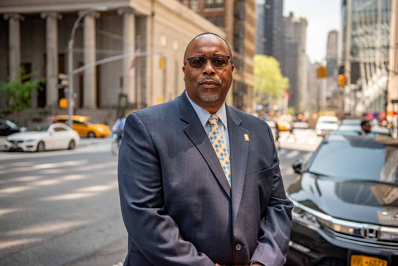 Portrait of Sean T. Campbell standing on the street