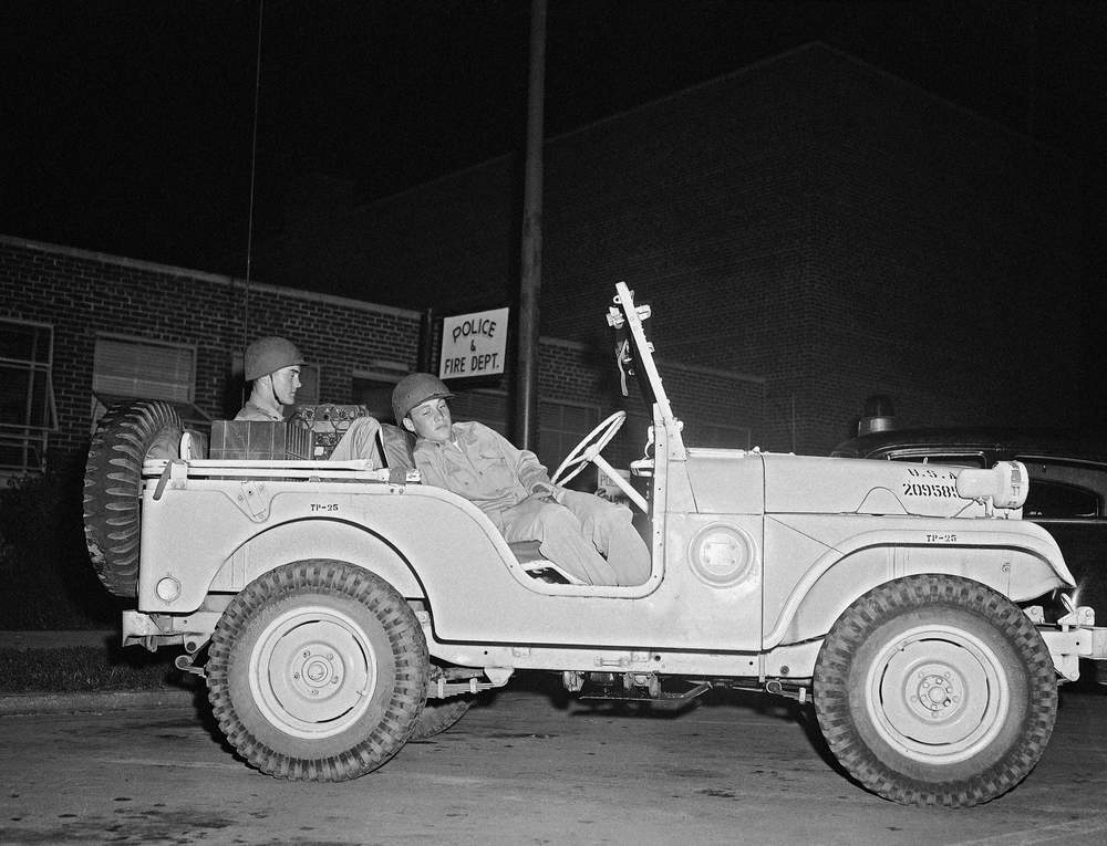 Two National Guardsmen sit in white radio jeep in Clinton, Tenn., on Sept. 5, 1956 during lull in rioting over school integration. On back seat is SPC\/3 Gene A. Overton of Dickson, Tennessee. (Rudolph Faircloth\/AP )