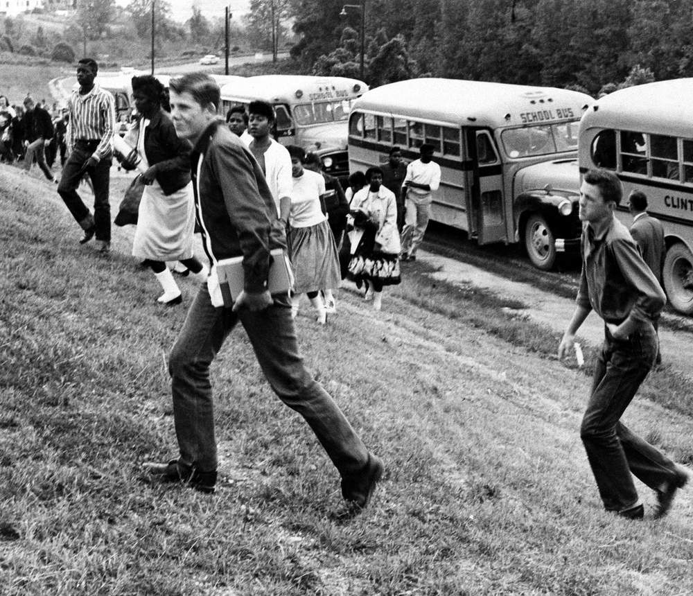 White and black students of the bombed Clinton High School climb up to their temporary school at nearby Oak Ridge, Tenn., Oct. 9, 1958. Violence has persisted  following desegregation in 1956. (AP Photo)